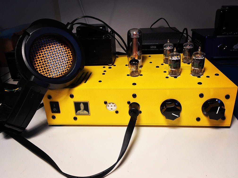 Bottlehead Stat Electrostatic Headphone Energizer in a yellow paint scheme with a pair of electrostatic headphones.